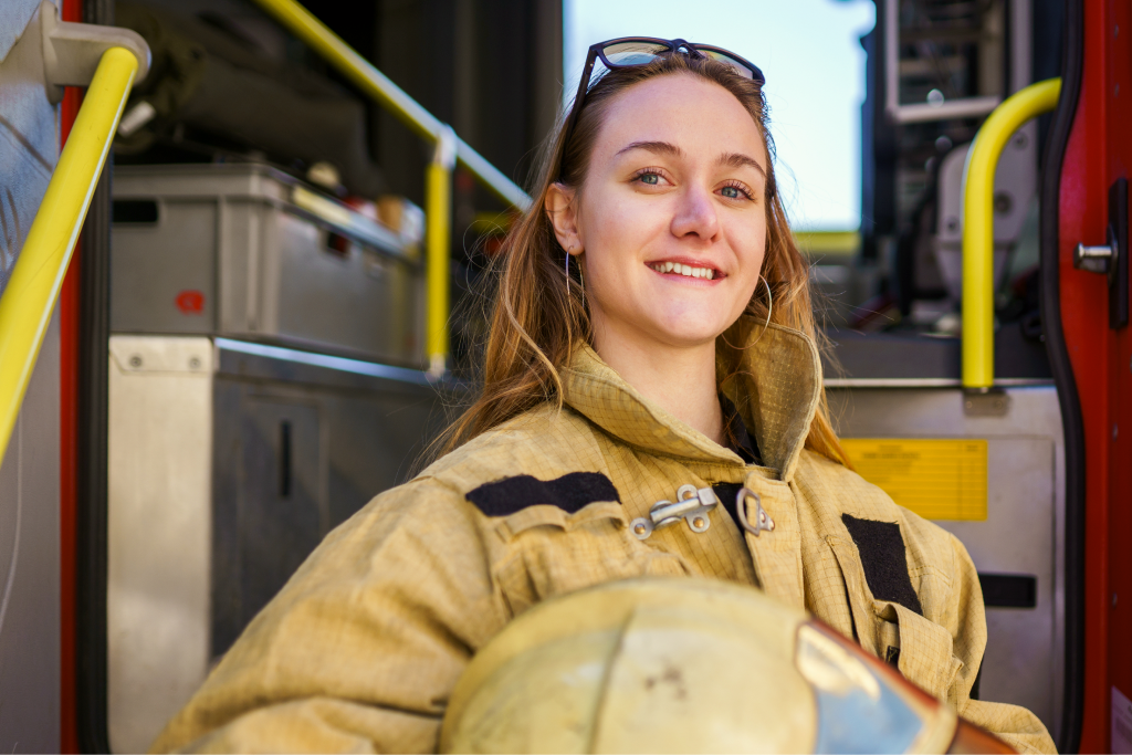 A firefighter in the cab of an engine